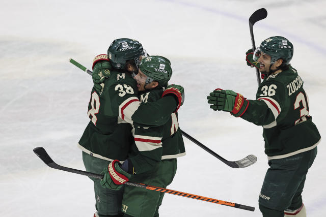 Minnesota Wild right wing Ryan Hartman (38) celebrates with defenseman Jared Spurgeon (46) after Hartman scored a goal against the Chicago Blackhawks during the third period of an NHL hockey game Saturday, March 25, 2023, in St. Paul, Minn. Minnesota won 3-1. (AP Photo/Stacy Bengs)