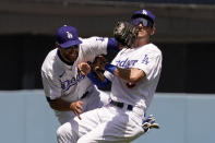 Los Angeles Dodgers left fielder Chris Taylor, left, collides with shortstop Trea Turner after catching a fly ball hit by Cincinnati Reds' Jake Fraley during the third inning of a baseball game Sunday, April 17, 2022, in Los Angeles. (AP Photo/Mark J. Terrill)