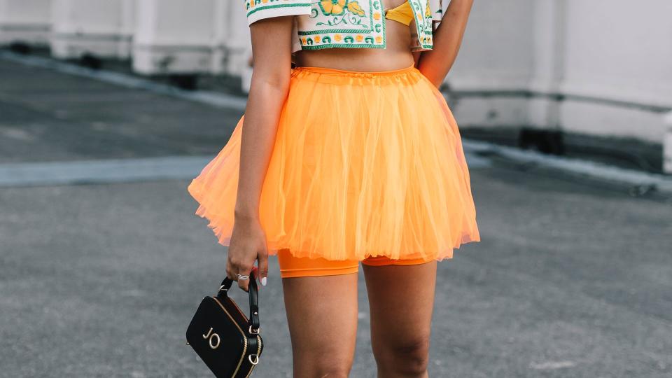 An attendee wears a traditional Filipino cropped jacket and orange tutu at Melbourne Fashion Festival 2024 on March 08, 2024 in Melbourne, Australia