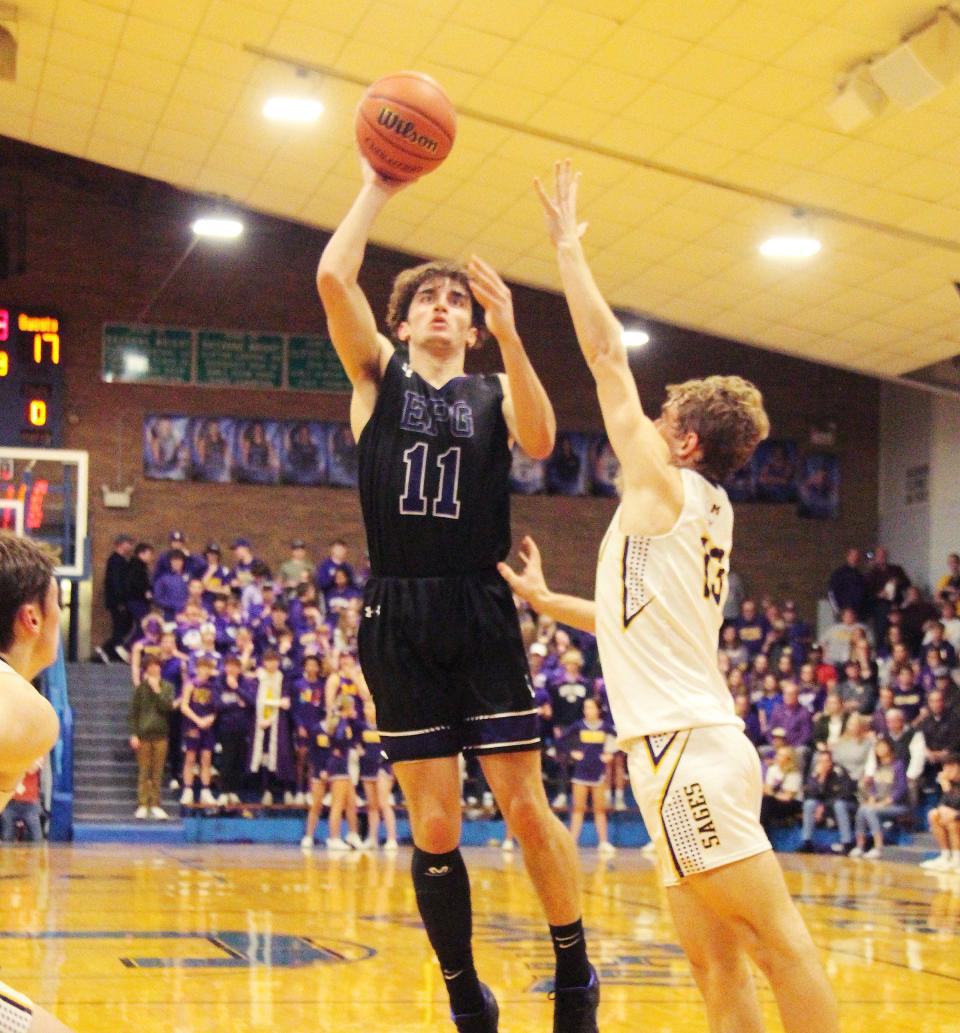 EPG's Asa Smith takes a shot in the lane over Monticello's Dylan Ginalick. Smith had 17 points to lead the Titans.