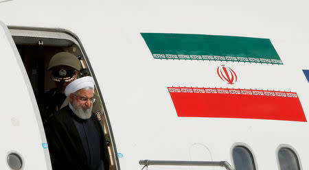 FILE PHOTO: Iranian President Hassan Rouhani disembarks from a plane upon his arrival at the airport in Zurich, Switzerland, July 2, 2018. REUTERS/Arnd Wiegmann/File Photo