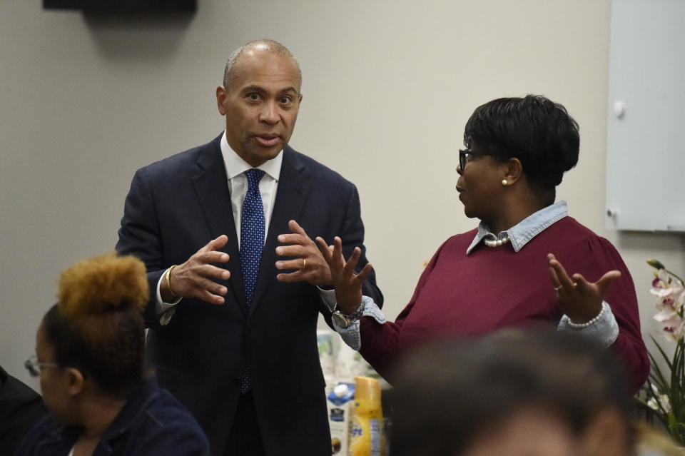 Former Massachusetts Gov. Deval Patrick, left, speaks with a business owner during a campaign stop, Tuesday, Nov. 19, 2019, in Columbia, S.C. (AP Photo/Meg Kinnard)