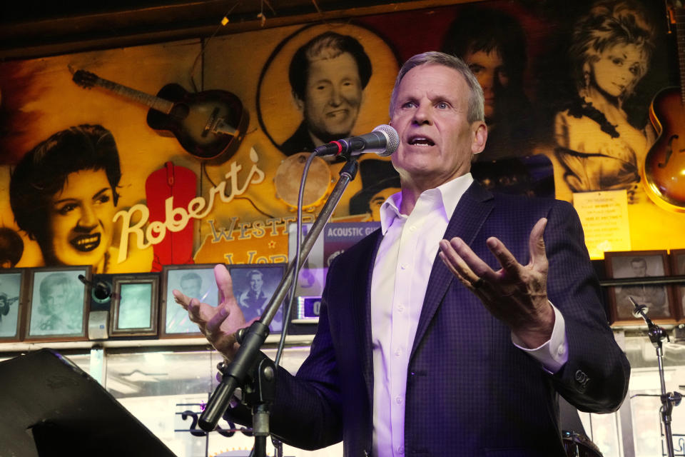 Gov. Bill Lee speaks before signing a bill Thursday, March 21, 2024, in Nashville, Tenn. The legislation is designed to protect songwriters, performers and other music industry professionals against the potential dangers of artificial intelligence. The signing took place in Robert's Western World, an historic honky tonk in downtown Nashville. On the wall behind Lee are pictures of country music stars Patsy Cline, left; Roy Acuff, center; and Dolly Parton, right. (AP Photo/Mark Humphrey)