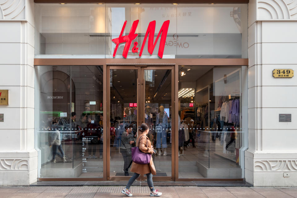 A woman walks by an H&M store in Shanghai, China Wednesday, March 24, 2021. 