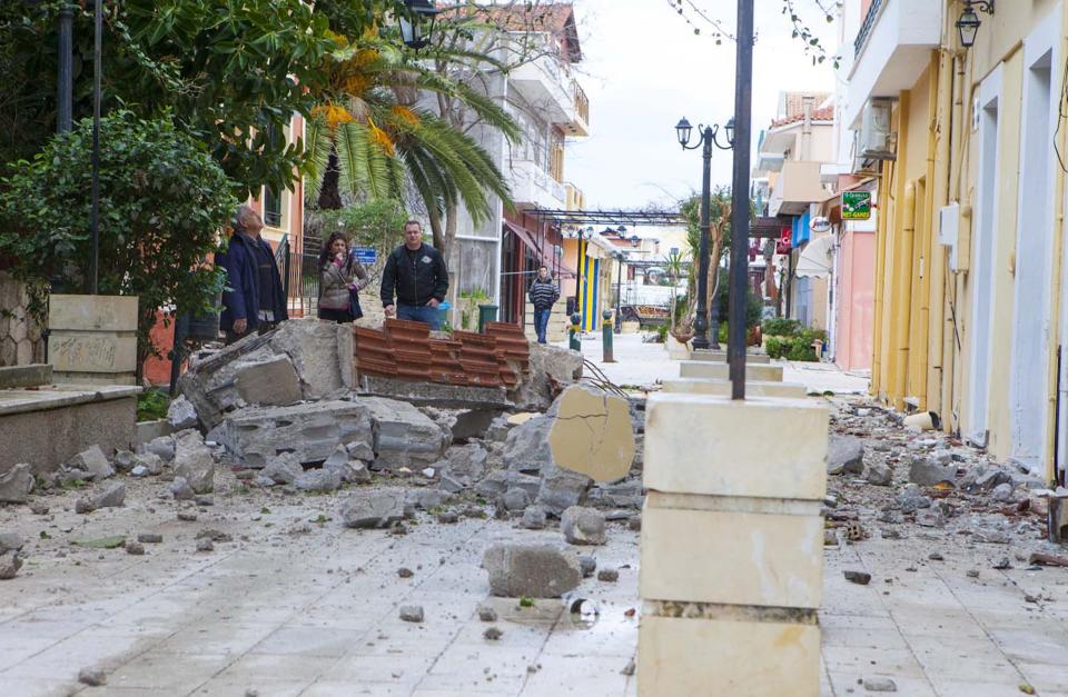 People look at damaged shops in the shopping street of Lixouri after an earthquake on the island of Kefalonia, western Greece on Monday, Feb. 3, 2014. A strong earthquake with a preliminary magnitude between 5.7 and 6.1 hit the western Greek island of Kefalonia before dawn Monday, sending scared residents into the streets just over a week after a similar quake damaged hundreds of buildings, reviving memories of a disaster in the 1950s. (AP Photo)