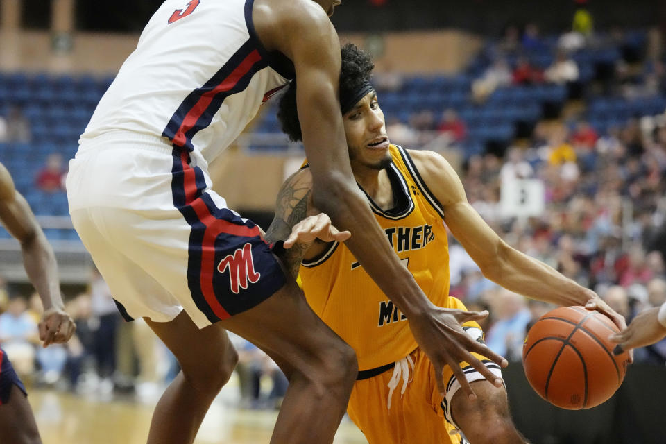 Southern Mississippi guard Andre Curbelo (11) pushes past Mississippi forward Jamarion Sharp (3) as he drives towards the basket during the second half of an NCAA college basketball game, Saturday, Dec. 23, 2023, in Biloxi, Miss. (AP Photo/Rogelio V. Solis)