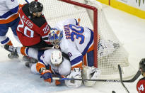 New Jersey Devils center Michael McLeod (20) and New York Islanders center Anders Lee (27) collide with Islanders goaltender Ilya Sorokin (30) in the net during the second period of an NHL hockey game, Sunday, Jan. 24, 2021, in Newark, N.J. (AP Photo/Kathy Willens)