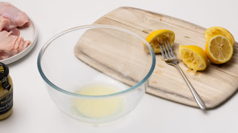 juicing lemons in a bowl