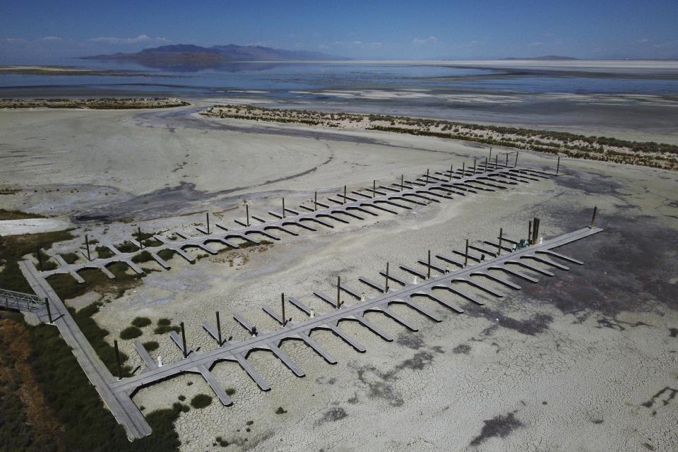 FILE - Empty docks are visible at the Antelope Island Marina due to record low water levels on Aug. 31, 2022, on the Great Salt Lake, near Syracuse, Utah. After years of sailboats being hoisted out of the shrinking Great Salt Lake amid fears they might not return, sailors are back this summer. (AP Photo/Rick Bowmer, File)