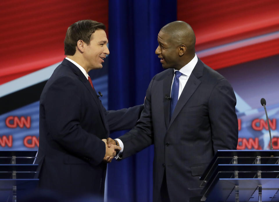 Ron DeSantis and Andre Gillum shake hands Sunday at the first debate in the Florida governor's race. (Photo: ASSOCIATED PRESS)