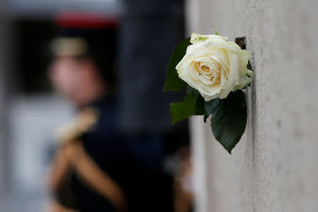 A white rose hangs near a commemorative plaque facing the 'Le Carillon' bar and 'Le Petit Cambodge' during a ceremony marking the second anniversary of the Paris attacks of November 2015 in which 130 people were killed, in Paris, France, November 13, 2017. REUTERS/Etienne Laurent/Pool