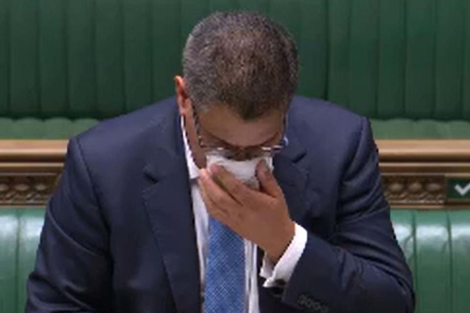 Feeling unwell: Business Secretary Alok Sharma wipes his face during a speech in the House of Commons (PA)