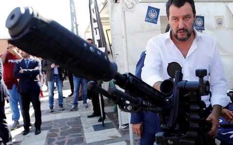  Matteo Salvini stands next to a sniper rifle during an event involving the state police SWAT team in Rome - Credit:  Remo Casilli/ REUTERS
