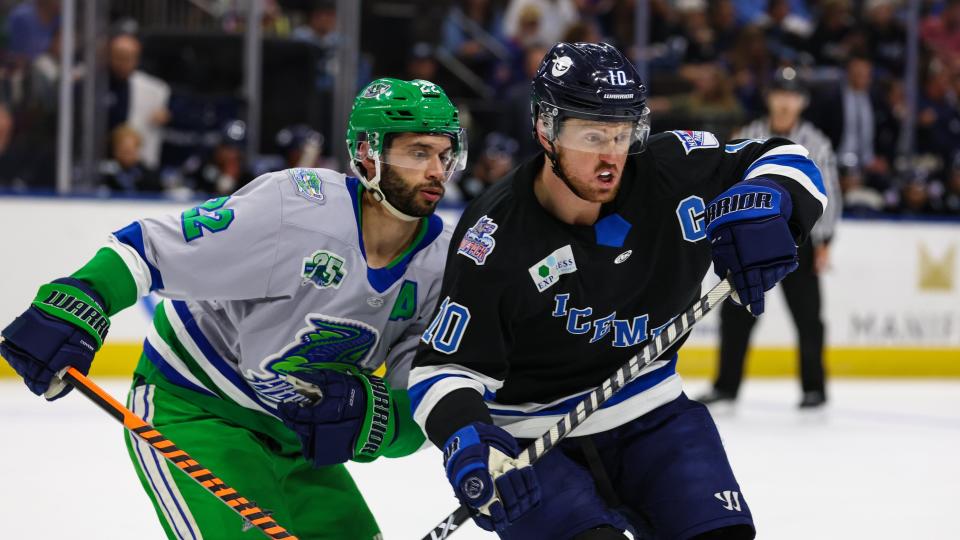 Florida Everblades forward Joe Pendenza (22) and Jacksonville Icemen forward Christopher Brown (10) jockey for position during Sunday's game.