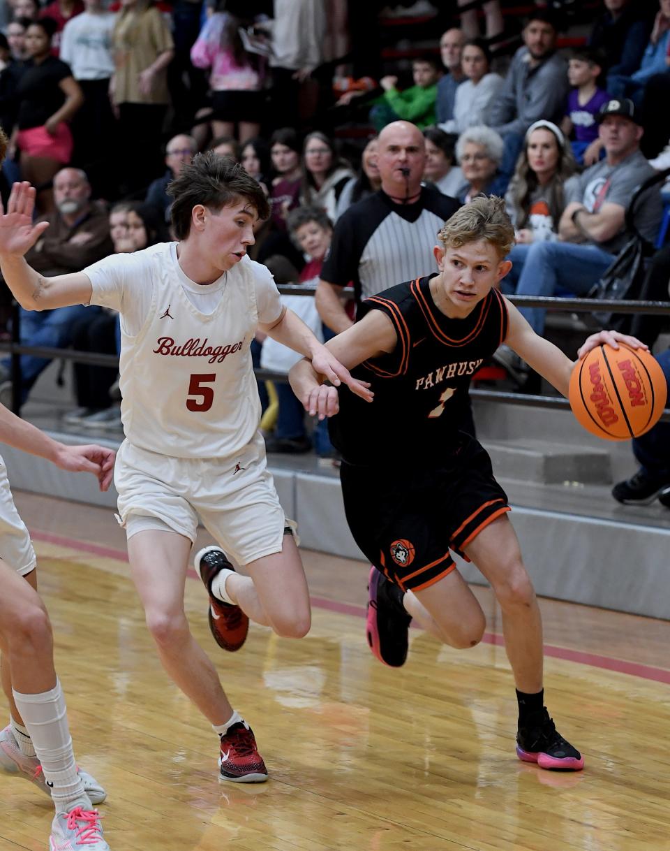 Dewey High School's senior Jace Wiliams (5) guards Pawhuska's Dax Godsey (1) during basketball action earlier in the season. Both Dewey and Pawhuska were eliminated in playoff action this weekend and are finished for the season.