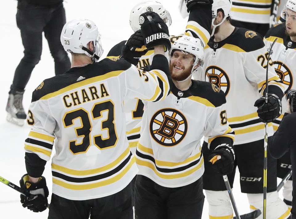 Boston Bruins defenseman Zdeno Chara (33), of Slovakia, celebrates with right wing David Pastrnak (88), of the Czech Republic, after the Bruins beat the St. Louis Blues in Game 6 of the NHL hockey Stanley Cup Final Sunday, June 9, 2019, in St. Louis. Both players scored goals as the Bruins won 5-1 to even the series 3-3. (AP Photo/Jeff Roberson)