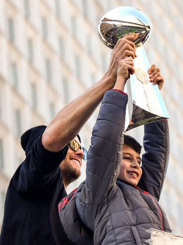 <p>Billie Weiss/Getty</p> Tom Brady of the New England Patriots holds the Vince Lombardi trophy with his son Benjamin Brady during the Super Bowl Victory Parade in Boston, Massachusetts on February 05, 2019.