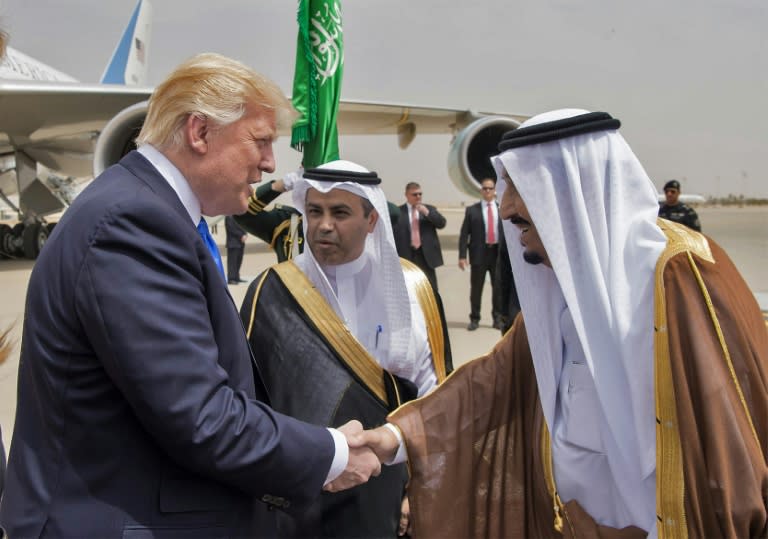 US President Donald Trump (L) shakes hands with Saudi King Salman bin Abdulaziz al-Saud (R) upon arrival at King Khalid International Airport in Riyadh on May 20, 2017