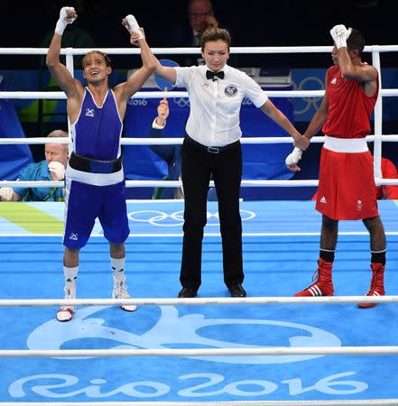 Aug 15, 2016; Rio de Janeiro, Brazil; Yoel Segundo Finol (VEN, blue) reacts after defeating Muhammad Ali (GBR, red) in a men's fly preliminary bout at Riocentro - Pavilion 6 during the Rio 2016 Summer Olympic Games. Mandatory Credit: John David Mercer-USA TODAY Sports