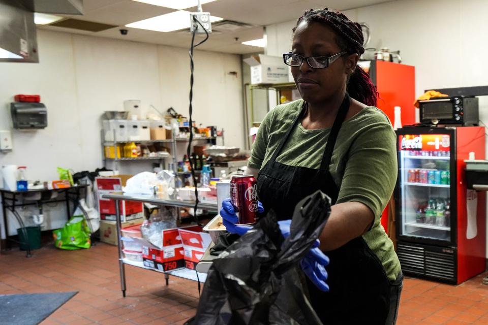 Trecia Leachmon prepares a to-go order for pickup at Leachmon's Pit Stop BBQ at Valley West Mall.