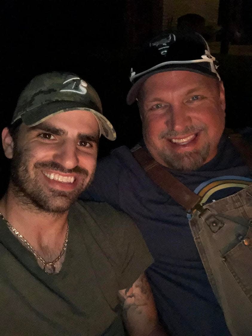 Mitch Rossell is shown with country music icon Garth Brooks. Brooks introduced Rossell when he debuted at the Grand Ole Opry in December.