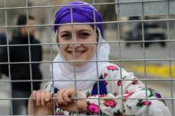 A woman poses behind a police fence on March 8, 2018 during a demonstration to mark International Women's Day in Diyarbakir, southeastern Turkey