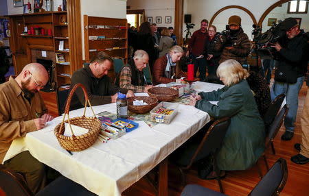 People write notes for victims and families at a vigil held at All Souls Unitarian Universalist Church, the day after a gunman opened fire on a Planned Parenthood clinic, in Colorado Springs, Colorado November 28, 2015. REUTERS/Isaiah J. Downing