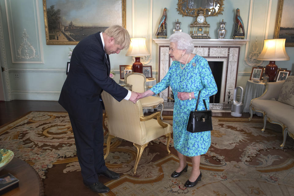 Queen Elizabeth II welcomes newly elected leader of the Conservative party, Boris Johnson during an audience where she invited him to become Prime Minister and form a new government in Buckingham Palace on July 24, 2019 in London, Englan