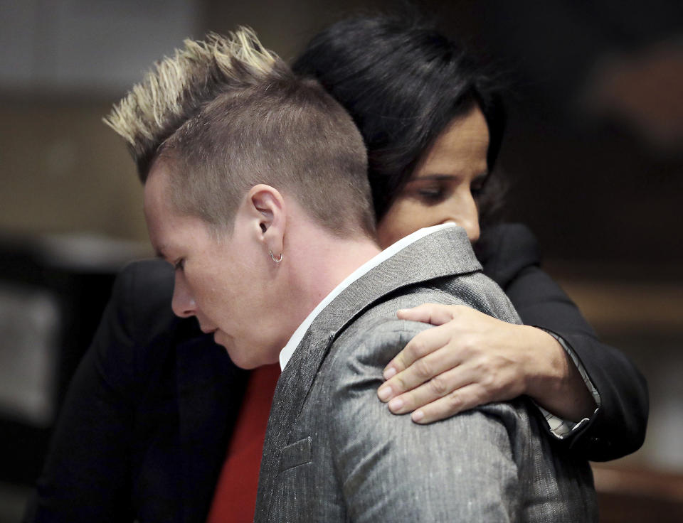 FILE - In this Oct. 14, 2019 file photo, April Alley, front, daughter of Sedley Alley, hugs a member of her legal counsel in a Memphis, Tenn., courtroom. Since the early 1990s, 22 death row inmates around the U.S. have been exonerated through DNA evidence. Now the Innocence Project hopes to exonerate Sedley Alley, a Tennessee man who has already been executed. Alley was put to death by lethal injection in 2006 for the murder two decades earlier of Marine Lance Cpl. Suzanne Collins. Alley said his confession was coerced. A judge is expected to rule Monday, Nov. 18 on whether DNA evidence can be tested. (Patrick Lantrip/Daily Memphian via AP, File)