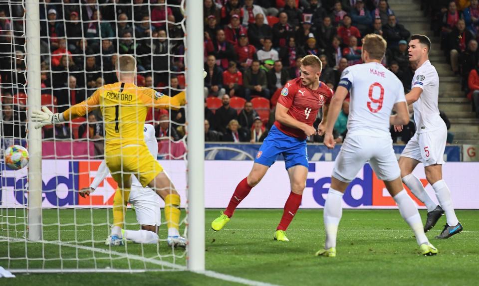 England's goalkeeper Jordan Pickford (L) fails to save  Czech Republic's defender Jakub Brabec's (2nd L) goal during the UEFA Euro 2020 qualifier Group A football match Czech Republic v England at the Sinobo Arena on October 11, 2019. (Photo by JOE KLAMAR / AFP) (Photo by JOE KLAMAR/AFP via Getty Images)