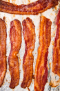 <p>There is no better way to cook bacon. Whatever you do, save that bacon fat to <a href="https://www.delish.com/cooking/recipe-ideas/a23499380/how-to-fry-an-egg/" rel="nofollow noopener" target="_blank" data-ylk="slk:cook eggs;elm:context_link;itc:0;sec:content-canvas" class="link ">cook eggs</a>, <a href="https://www.delish.com/cooking/recipe-ideas/recipes/a52754/bacon-asparagus-dippers-recipe/" rel="nofollow noopener" target="_blank" data-ylk="slk:roast vegetables;elm:context_link;itc:0;sec:content-canvas" class="link ">roast vegetables</a>, or <a href="https://www.delish.com/cooking/recipe-ideas/g1005/popcorn-recipes/" rel="nofollow noopener" target="_blank" data-ylk="slk:pop popcorn;elm:context_link;itc:0;sec:content-canvas" class="link ">pop popcorn</a>!</p><p>Get the <strong><a href="https://www.delish.com/cooking/a22502749/how-to-cook-bacon-in-the-oven-recipe/" rel="nofollow noopener" target="_blank" data-ylk="slk:Oven-Baked Bacon recipe;elm:context_link;itc:0;sec:content-canvas" class="link ">Oven-Baked Bacon recipe</a>. </strong></p>