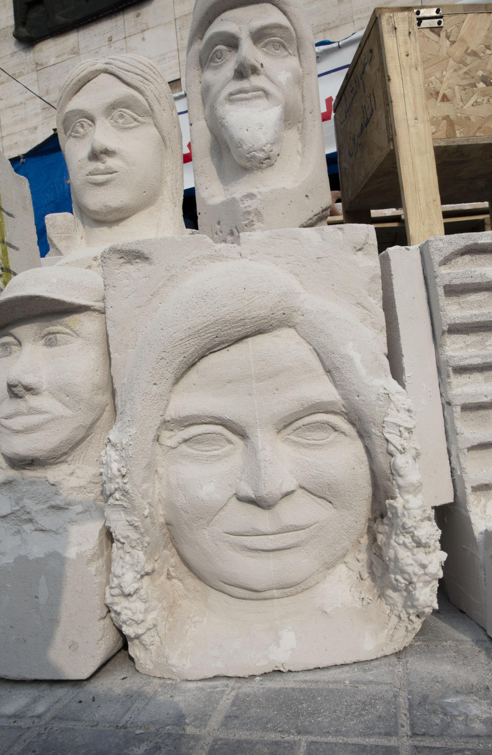 In this Sunday, Dec. 15, 2019, photo, completed sculptures wait to be stored in preparation for an upcoming art exhibition, during the ongoing protests in Tahrir square, Baghdad, Iraq. Tahrir Square has emerged as a focus of the protests, with protesters camped out in dozens of tents. Dozens of people took part in the simple opening of the sculpture exhibition. (AP Photo/Nasser Nasser)