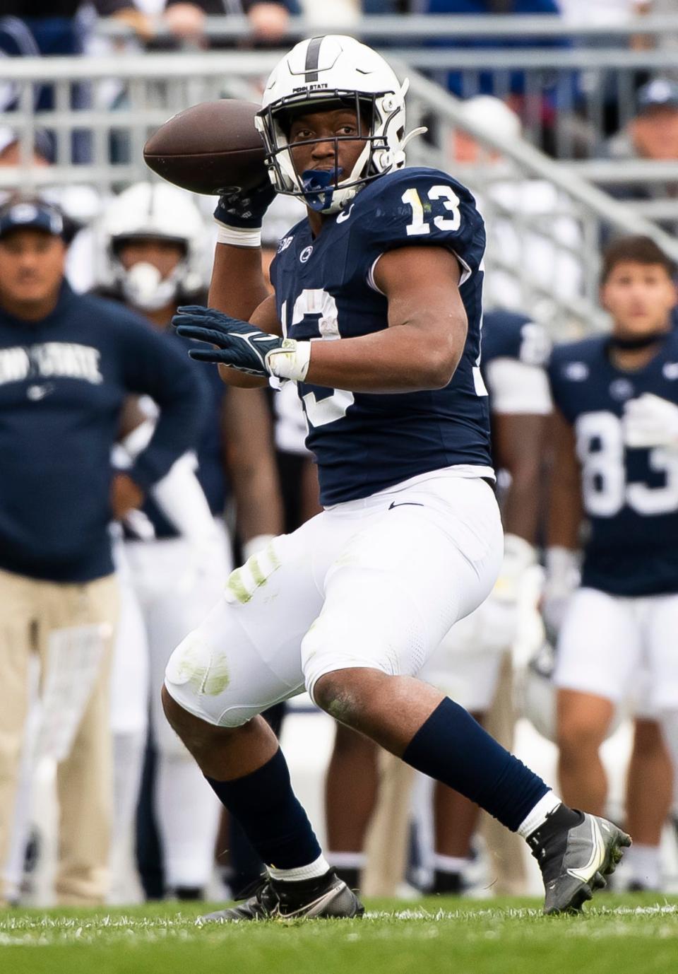 Penn State running back Kaytron Allen throws a pass to quarterback Drew Allar for a first down during an NCAA football game against Michigan Saturday, Nov. 11, 2023, in State College, Pa.