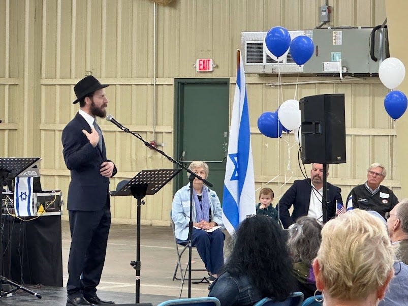 Rabbi Yeshayahu Tenenboim of Chabad of the Emeral Coast speaking during Sunday night's rally.