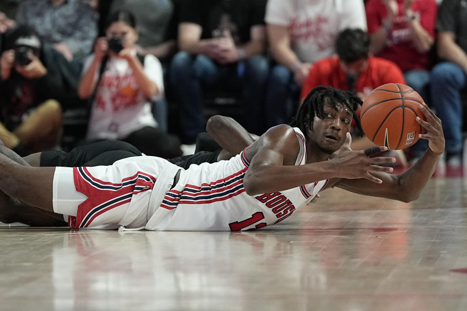 Houston guard Tramon Mark dives for a loose ball during the first half of an NCAA college basketball game against Norfolk State, Tuesday, Nov. 29, 2022, in Houston. (AP Photo/Kevin M. Cox)