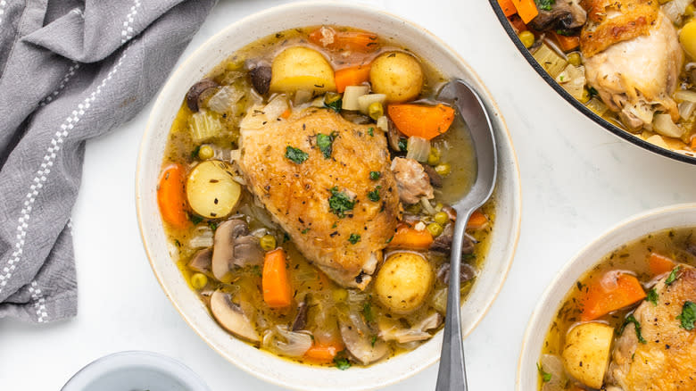 Chicken and vegetable casserole in bowl with spoon