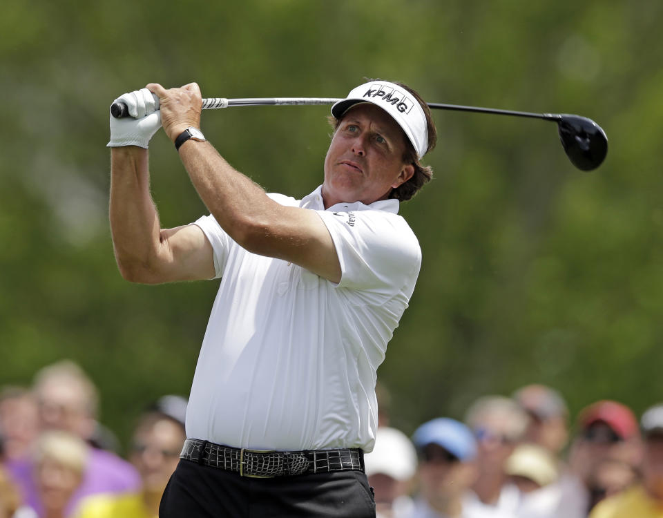 Phil Mickelson watches his tee shot on the fourth hole during the first round of the Wells Fargo Championship golf tournament in Charlotte, N.C., Thursday, May 1, 2014. (AP Photo/Chuck Burton)