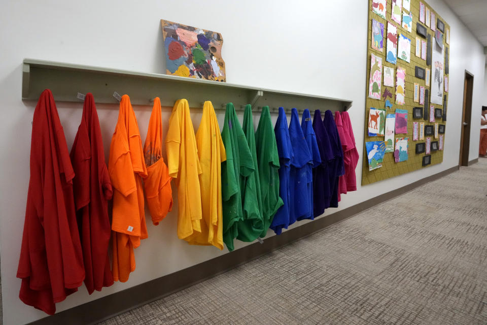 Students' smocks hang in a remodeled hallway in The Covenant School in Nashville, Tenn., Tuesday, June 25, 2024. The school reopened a little over a year after three students and three adults were killed in a shooting at the school. (AP Photo/Mark Humphrey)