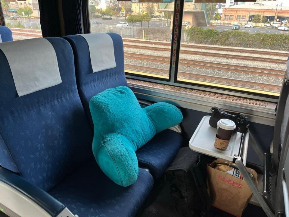 big pillow sitting on an amtrak train seat