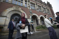 Tun Khin, President of the Burmese Rohingya Organisation UK, right, and Yasmin Ullah of the Rohingya community, left, react outside the International Court in The Hague, Netherlands, Thursday, Jan. 23, 2020, after the court ordered Myanmar take all measures in its power to prevent genocide against the Rohingya. The United Nations' top cour issued a decision on a request by Gambia. (AP Photo/Peter Dejong)