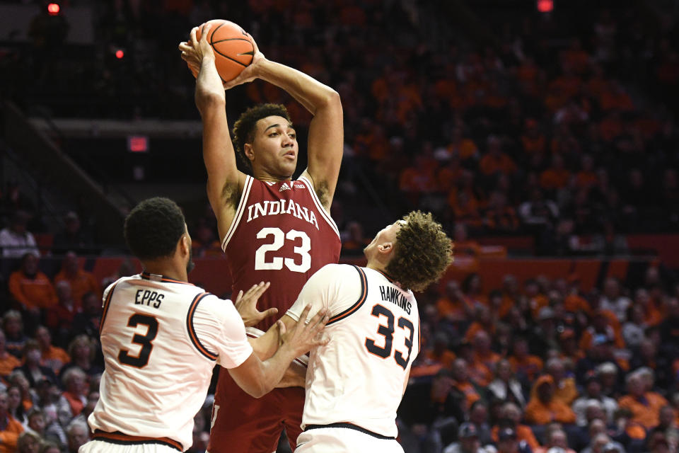 Indiana's Trayce Jackson-Davis (23) passes as Illinois' Jayden Epps (3) and Coleman Hawkins (33) defend during the second half of an NCAA college basketball game, Thursday, Jan. 19, 2023, in Champaign, Ill. (AP Photo/Michael Allio)