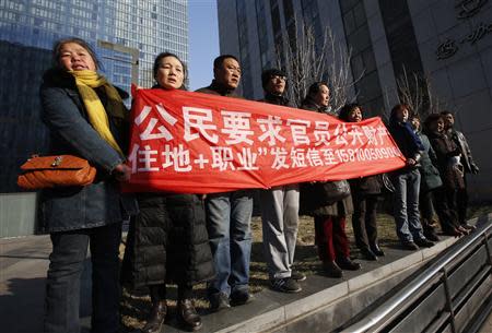 Supporters of Xu Zhiyong, one of China's most prominent rights advocates, shout slogans near a court where Xu's trial is being held, in Beijing January 22, 2014. REUTERS/Kim Kyung-Hoon