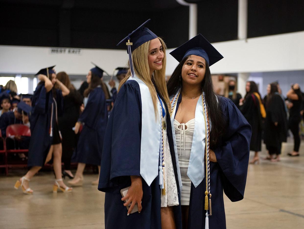 West Boca Raton Community High School students Pantecha Sartipi, left, and Sujey Trejo pose for a photos before their graduation ceremony at the South Florida Fairgrounds in West Palm Beach Monday May 16, 2022.