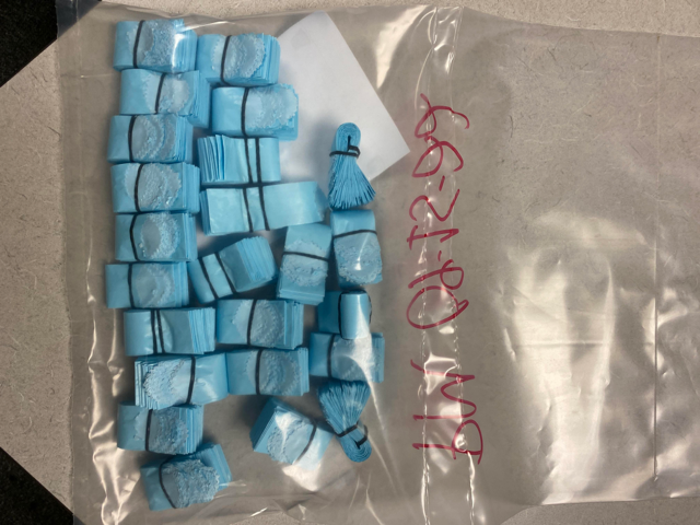 Providence police accuse a city employee of distributing fentanyl, on the job, in small blue bags.
