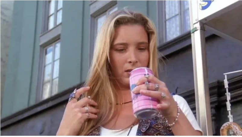 Phoebe looking at a soda can