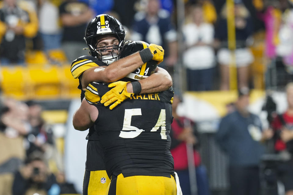 Pittsburgh Steelers tight end Pat Freiermuth, top, reacts with center Zach Frazier after scoring on a touchdown catch against the Dallas Cowboys during the second half of an NFL football game, early Monday, Oct. 7, 2024, in Pittsburgh. (AP Photo/Matt Freed)