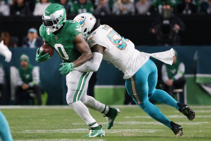 Philadelphia Eagles running back D'Andre Swift (0) is tackled by Miami Dolphins linebacker Jerome Baker on Sunday at Lincoln Financial Field in Philadelphia. Photo by Laurence Kesterson/UPI