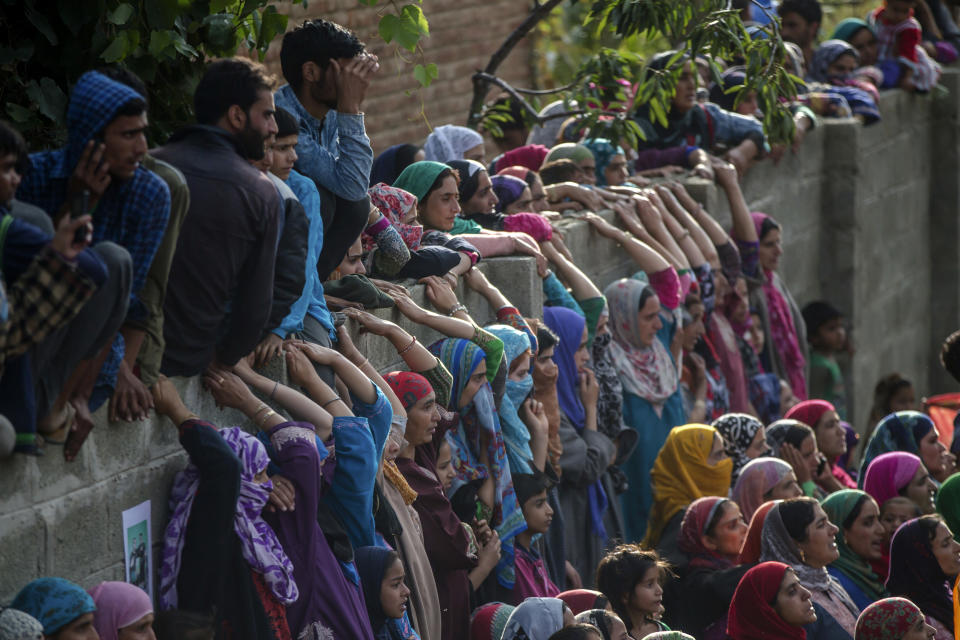 Kashmiri villagers watch the funeral procession of top rebel commander Gulzar Ahmed Paddroo in Aridgeen, about 75 kilometers south of Srinagar, Indian controlled Kashmir, Saturday, Sept 15, 2018. Indian troops laid a siege around a southern village in Qazigund area overnight on a tip that militants were hiding there, police said. A fierce gunbattle erupted early Saturday, and hours later, five local Kashmiri rebels were killed. (AP Photo/Dar Yasin)