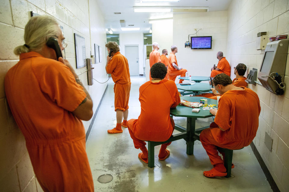 FILE - In this Friday, July 13, 2018 file photo, inmates pass the time within their cell block at the Twin Falls County Jail in Twin Falls, Idaho. In March 2020, the COVID-19 coronavirus and its lingering threat has become a potential “get out of jail card” for inmates who argue it’s not a matter of if but when the deadly illness sweeps through tightly packed populations behind bars. (Pat Sutphin/The Times-News via AP)