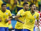 (L-R) Brazil's Paulinho, Daniel Alves and Neymar celebrates a goal by Neymar during the 2014 World Cup opening match between Brazil and Croatia at the Corinthians arena in Sao Paulo June 12, 2014. (REUTERS/Murad Sezer)